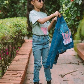 Weightless Pink Elephant Denim Jacket, modeled in the garden