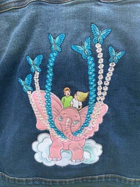 Weightless Pink Elephant embroidery closeup: the elephant lifted by butterflies